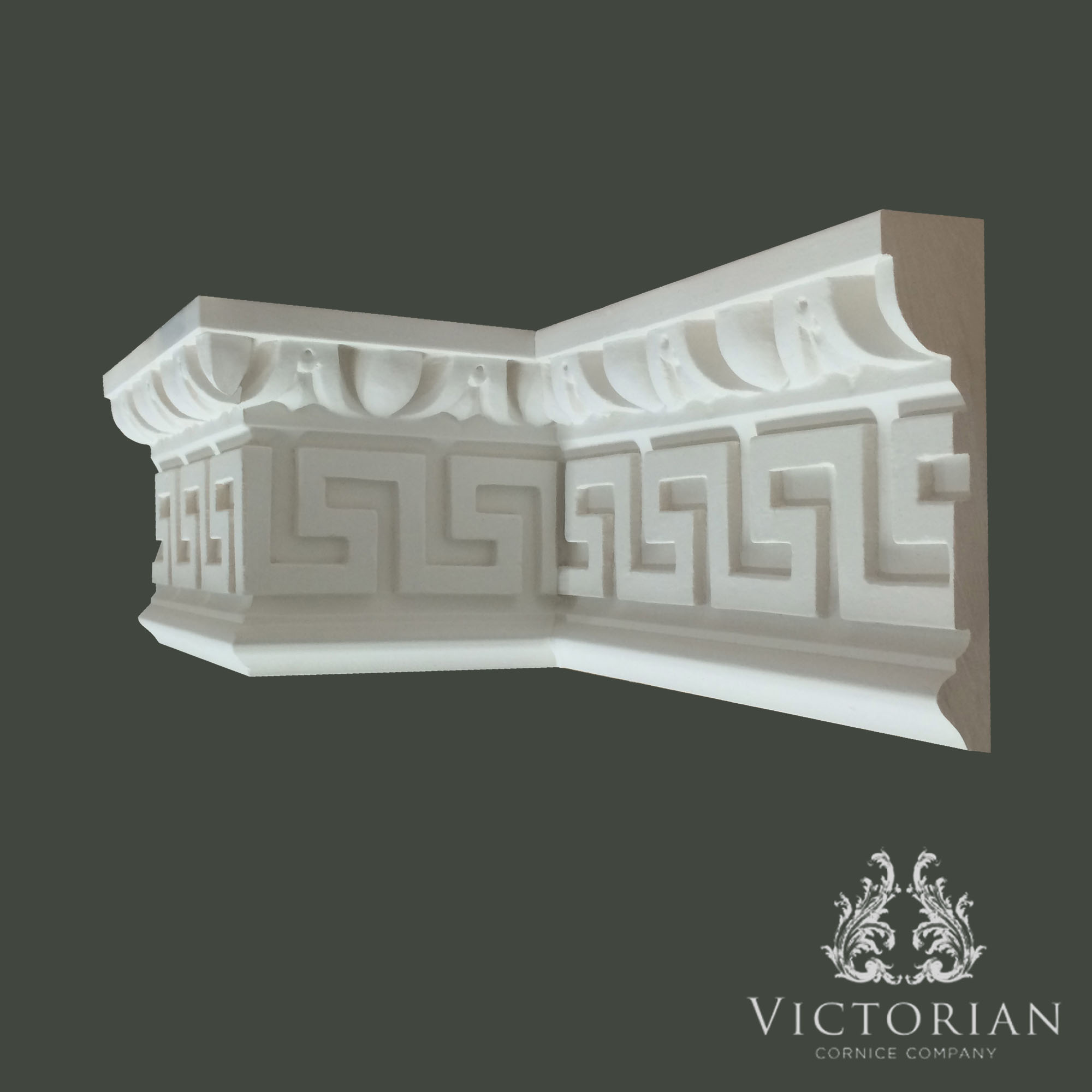 Decorative Greek key plaster cornice with classical geometric pattern and dentil-style upper detailing
