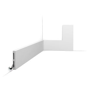 ORAC DX163-2300 modern LED skirting board with integrated cable management, installed along the base of a wall for concealed wiring and indirect lighting.