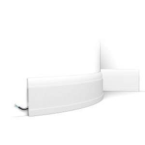 Flexible skirting board installed on curved wall with concealed cable management
