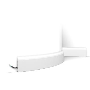 Flexible skirting board with smooth rounded top fitted to curved wall with concealed cable channel