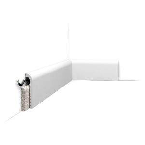 ORAC SX185 rounded skirting board with integrated cable management, installed along the base of a wall to conceal wiring while providing a soft contemporary finish.