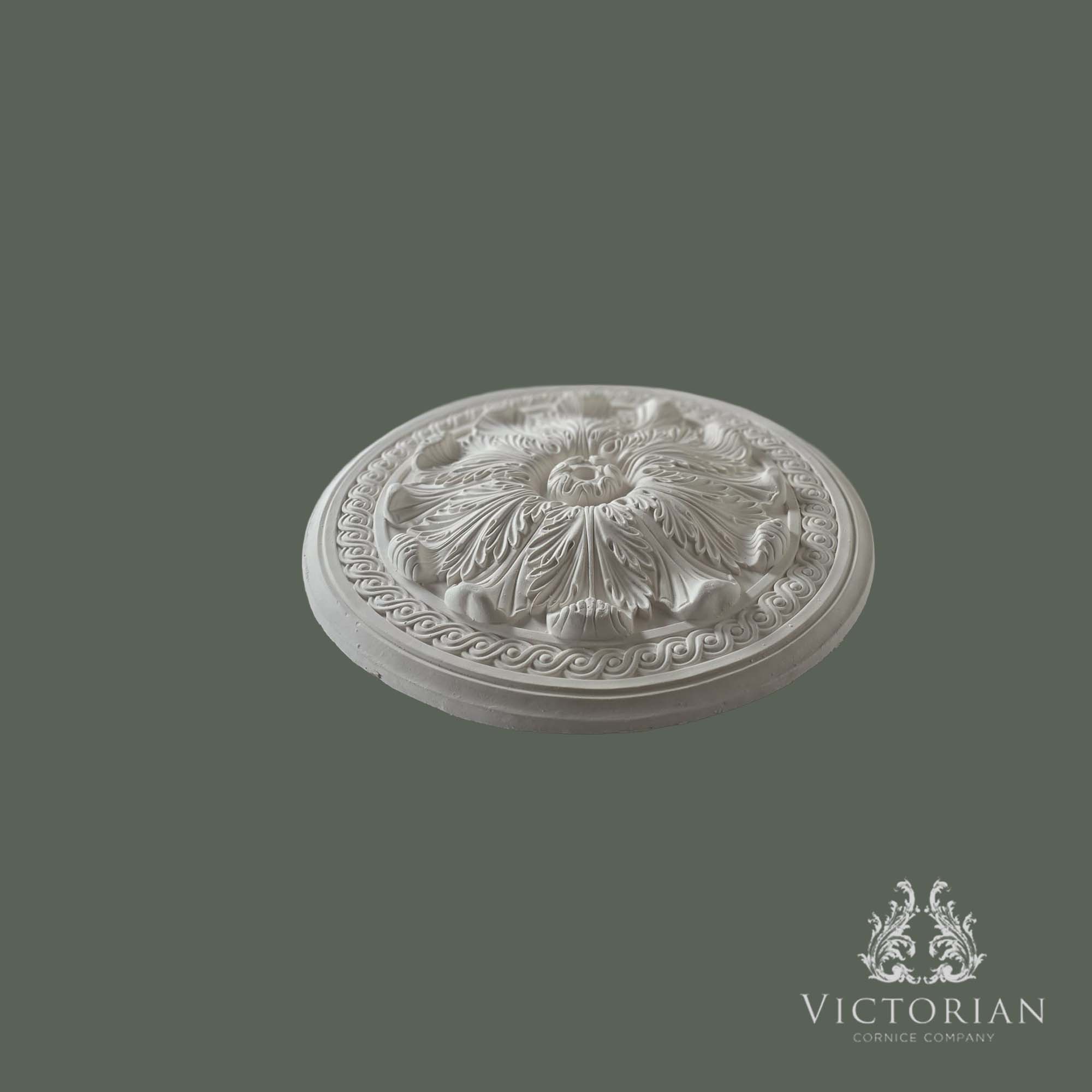 Side profile of the R17 handmade plaster ceiling rose showing its raised acanthus leaf design, decorative Greek key border and handcrafted plaster construction.