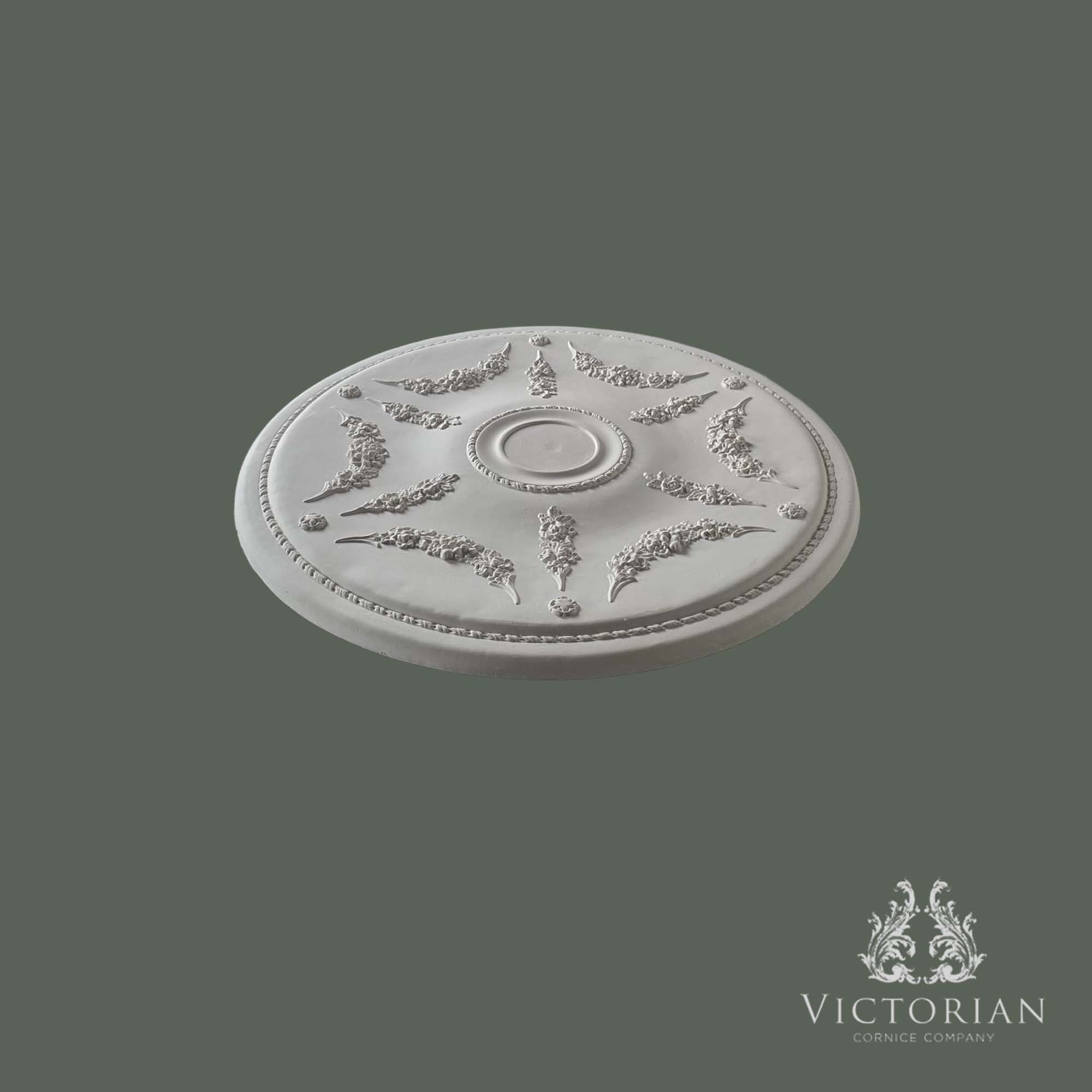 Side profile of the R23 handmade plaster ceiling rose showing its shallow projection, delicate floral garland detailing, and fine rope border.