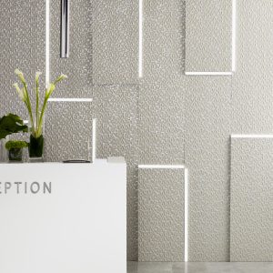 Modern commercial interior featuring textured Lincrusta Checkers wallcovering with geometric panel installation