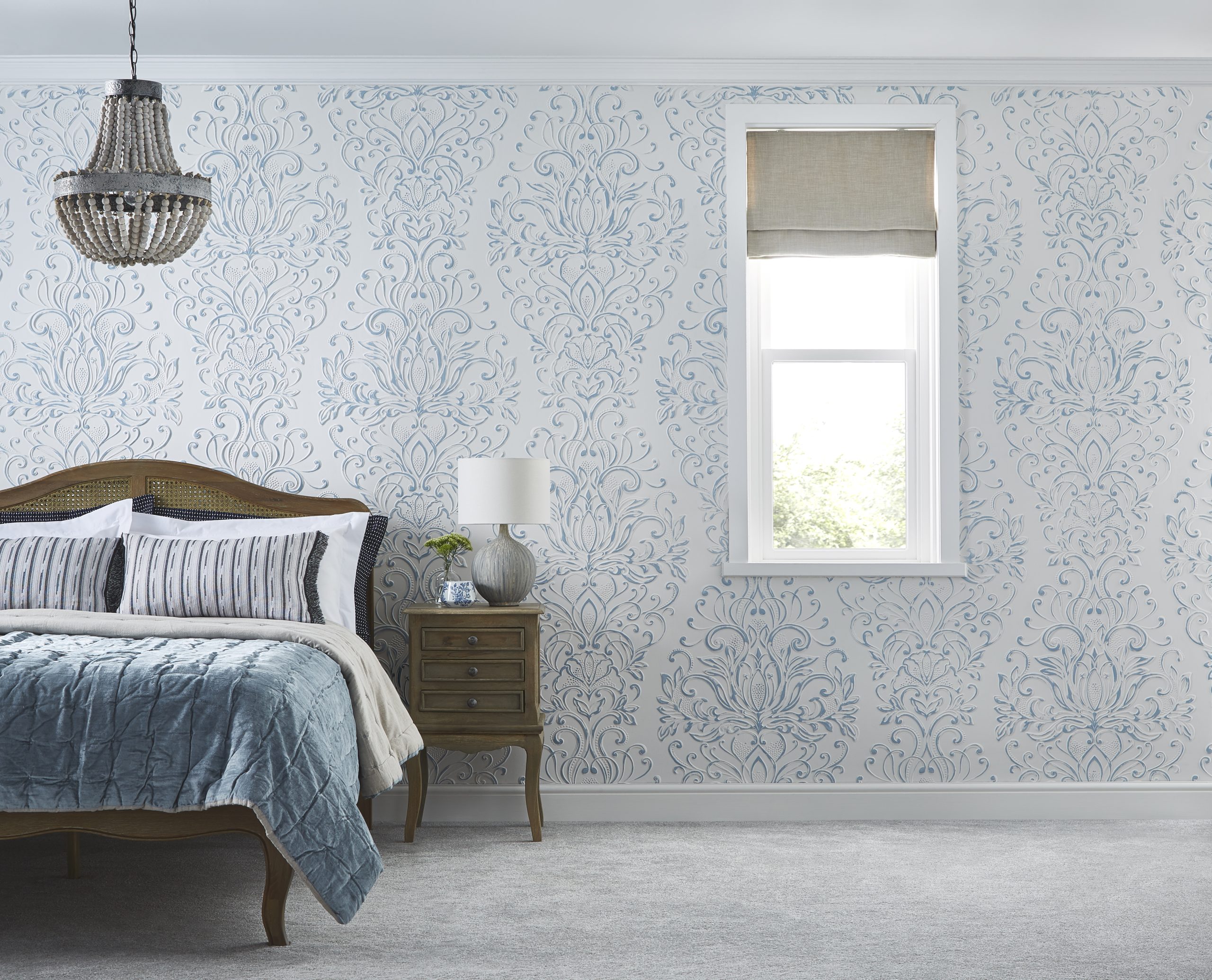 Bedroom interior featuring Lincrusta Cleo embossed wallcovering in white and pale blue
