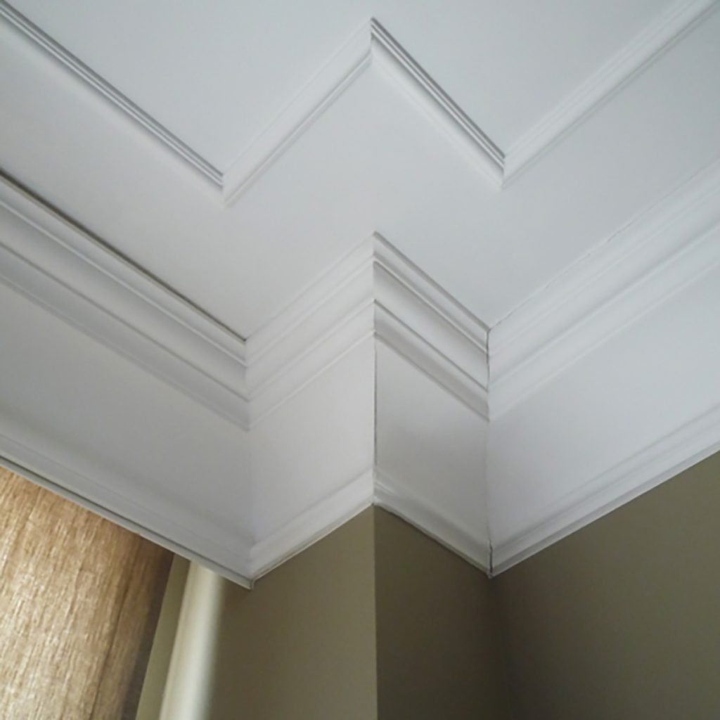 Orac coving installed at ceiling junction with clean mitred corner detail in a modern interior