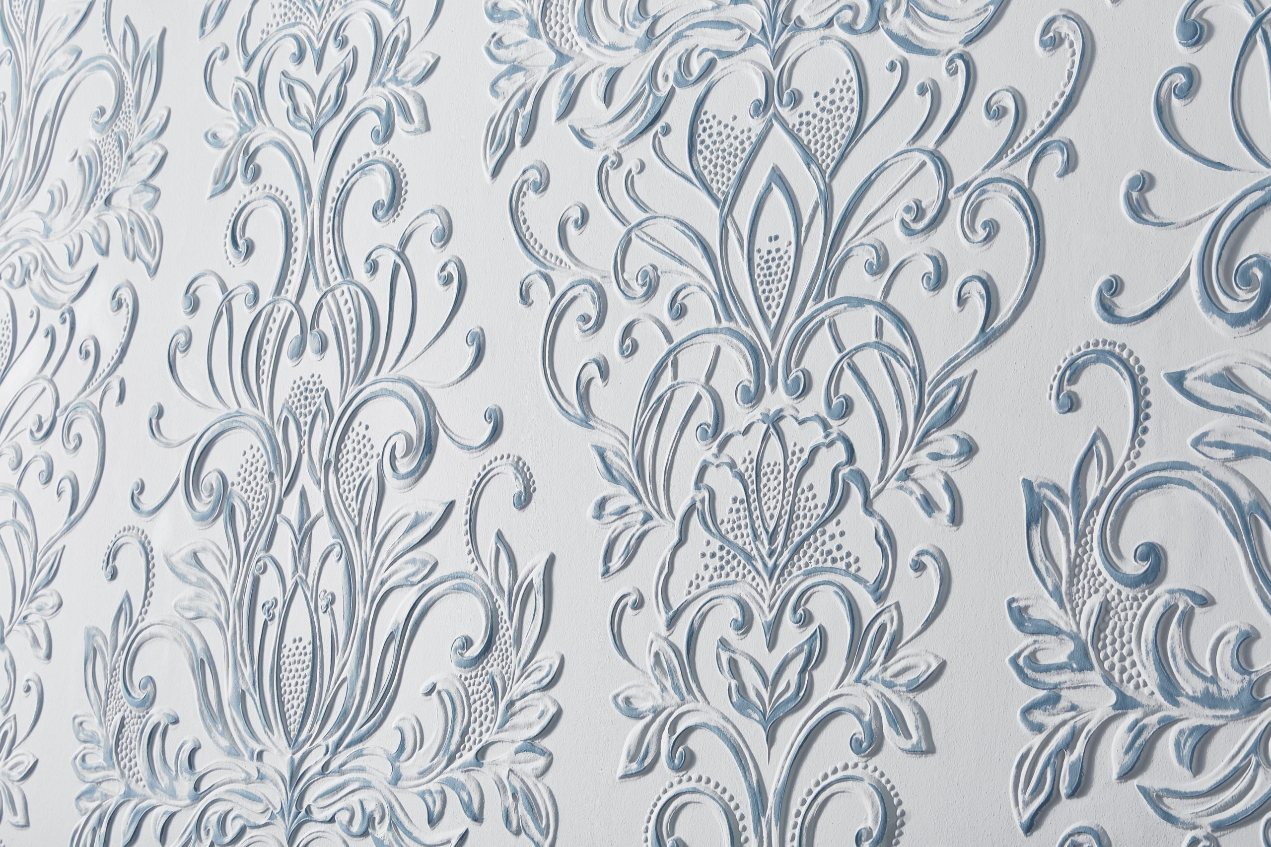 Lincrusta Cleo wallcovering with embossed floral scroll pattern in white and soft blue