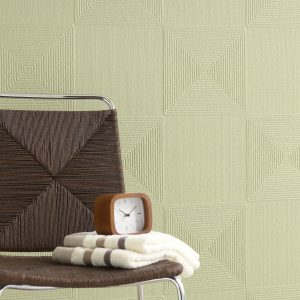 Lincrusta geometric wallcovering with textured pyramid pattern in soft green interior setting