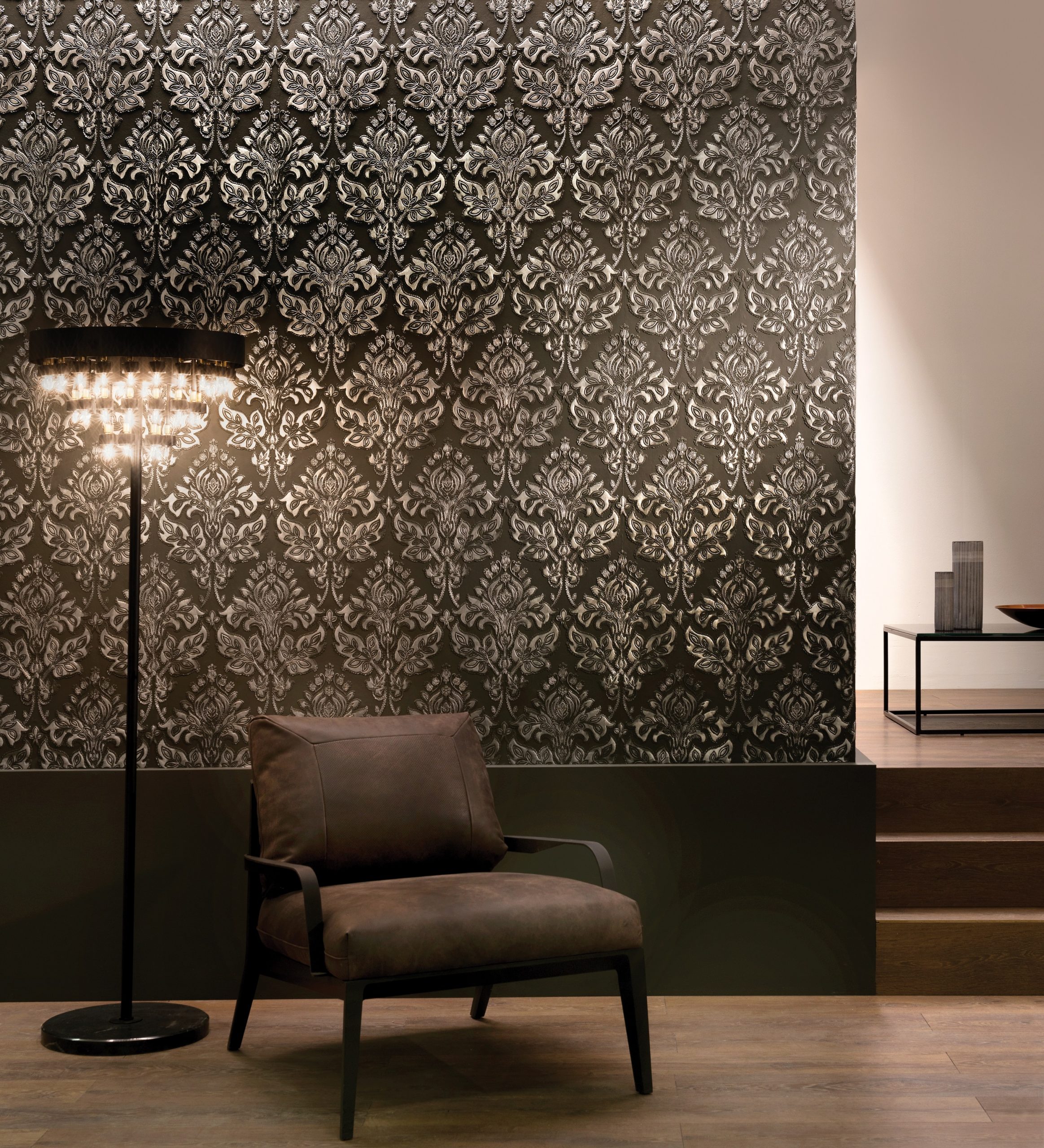 Dark embossed Lincrusta wallcovering with ornate damask pattern in a contemporary luxury interior