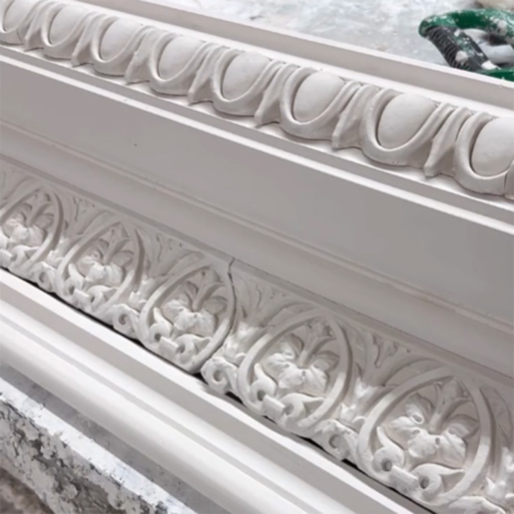 Restored plaster cornice showing detailed ornamental design matched to original profile