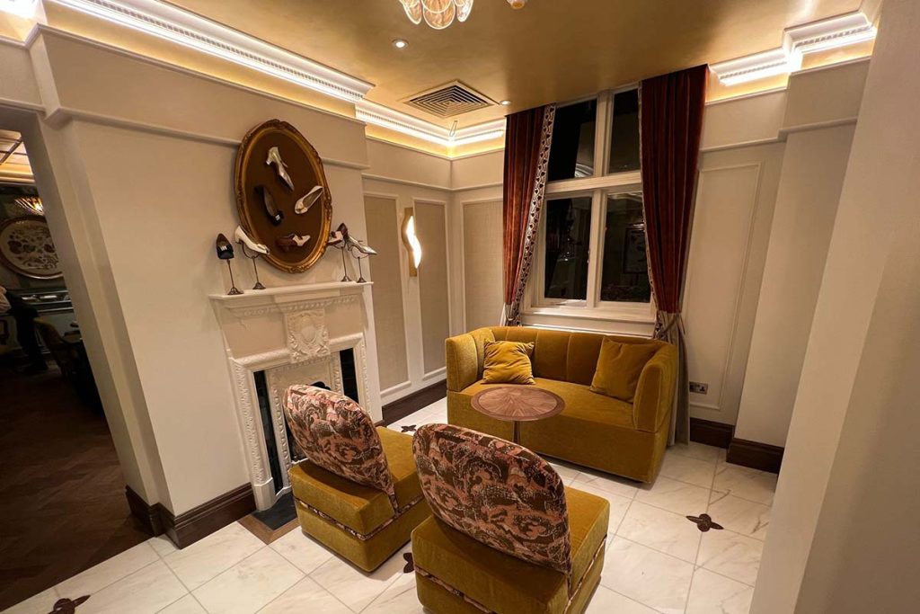 Main entrance hall at The Sloane Club, London featuring bespoke plaster cornice, wall panelling and decorative mouldings installed by Victorian Cornice Company.