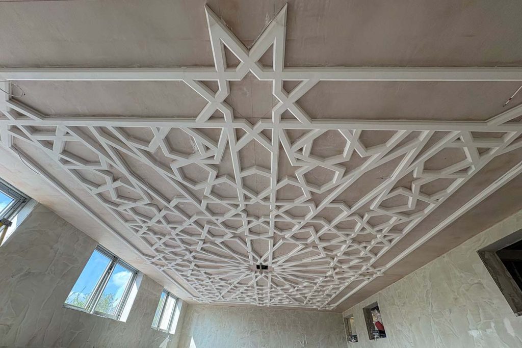 Wide view of the bespoke plaster ceiling installation nearing completion at Birmingham Central Mosque.