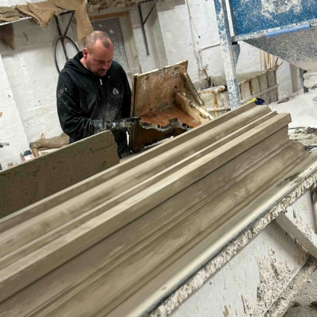 Finished handmade exterior cornice on a workbench in the Victorian Cornice Company workshop, manufactured using traditional methods.