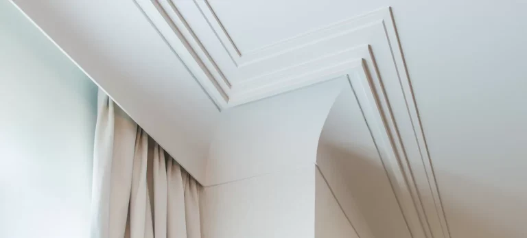 Modern stepped plaster cornice installed around the ceiling of a contemporary interior
